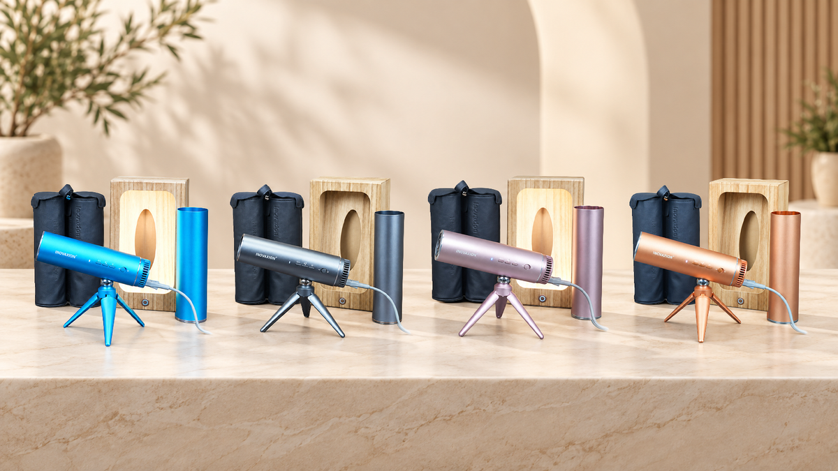 De LeLunar HandsFreeDryer set in Bondi Blue, Space Grey, Sunset Rose en Amber Gold: föhn, inklapbaar statief, wandhouder en reiscapsule, op een marmeren blad